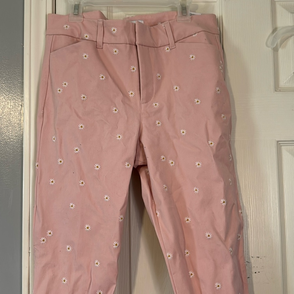 pink dress pants with embroidered daisy details